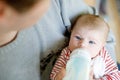 Father feeding newborn baby daughter with milk in nursing bottle Royalty Free Stock Photo