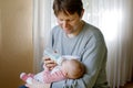 Father feeding newborn baby daughter with milk in nursing bottle Royalty Free Stock Photo