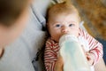 Father feeding newborn baby daughter with milk in nursing bottle Royalty Free Stock Photo