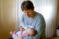 Father feeding newborn baby daughter with milk in nursing bottle Royalty Free Stock Photo