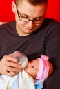 Father feeding newborn baby girl with milk bottle Royalty Free Stock Photo