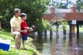 Father Fishing With His Son On A RIver