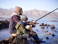 Father, fishing rod and young boy on rocks, shoreline and bonding for activity by ocean. Sea, catch and learning how to