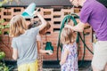 Father gardening at home with three daughter Royalty Free Stock Photo