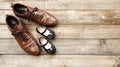 Father and girl brown shoes on wooden background, fathers day Royalty Free Stock Photo