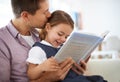 Father, girl and reading book in family home, smile and daughter with happy expression. Childcare, development and Royalty Free Stock Photo