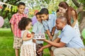 Father gives birthday cake with burning candle on Royalty Free Stock Photo