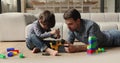 Father gives high five, praises son for repaired toy car