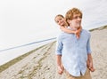 Father giving daughter piggy back ride at beach Royalty Free Stock Photo