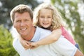 Father giving daughter piggyback Royalty Free Stock Photo