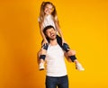 Father Giving Daughter Piggyback Ride Smiling At Camera, Studio Shot Royalty Free Stock Photo