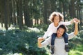 Father Giving Daughter Ride On Shoulders In Countryside