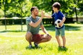 Father giving five to son with soccer ball at park Royalty Free Stock Photo