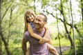 Father giving his daughter a piggyback ride, having fun Royalty Free Stock Photo