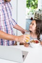 Father giving juice to daughter Royalty Free Stock Photo