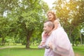 Father giving a piggyback ride to his daughter at park Royalty Free Stock Photo