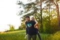 Father giving piggyback ride to small daughter on a walk Royalty Free Stock Photo