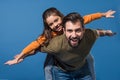 father giving piggyback to daughter