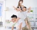 Father giving piggyback to excited child and playing at home