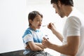 Father Giving Son Cough Syrup Royalty Free Stock Photo