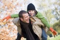 Father giving son piggyback Royalty Free Stock Photo