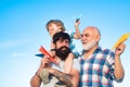 Father giving son ride on back in park. Generation concept. Cute son with dad playing outdoor. Portrait of happy father Royalty Free Stock Photo