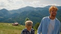 Father going hill boy sunny day closeup. Man enjoying holiday walking with son. Royalty Free Stock Photo