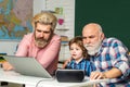 Father, Grandfather and son studies at home and does school homework. Cute little boy studying. Elementary schoolboy. Royalty Free Stock Photo