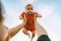 Father hands holding up infant baby outdoor Royalty Free Stock Photo