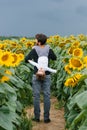 A father is having fun with his little son, walking through a field with sunflowers on a summer day Royalty Free Stock Photo