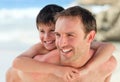 Father having son a piggyback on the beach Royalty Free Stock Photo