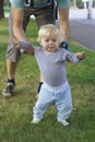 Father hedging their baby, toddler learning to walk Royalty Free Stock Photo