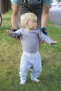 Father hedging their baby, toddler learning to walk Royalty Free Stock Photo