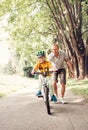 Father help his little son ride bicycle Royalty Free Stock Photo