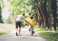 Father help his son ride a bicycle Royalty Free Stock Photo