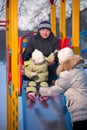 Father helping baby to slide down, mother catch Royalty Free Stock Photo