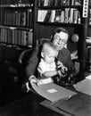 Father helping baby use telephone Royalty Free Stock Photo