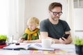 Father helping child do his homework at home. Homeschooling, distance learning, online studying, remote education for kids during Royalty Free Stock Photo