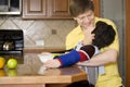 Father helping disabled son work in kitchen