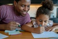 A father helping his daughter with homeschool. Royalty Free Stock Photo