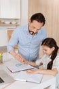 Father helping his daughter to inscribe a circle