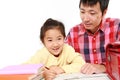 Father helping his daugther doing homework Royalty Free Stock Photo