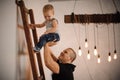 Father helping his little son climbing up the ladder Royalty Free Stock Photo
