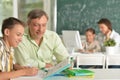 Father helping his son doing homework in classroom Royalty Free Stock Photo