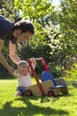 Father helping his son in garden to take his first step of life Royalty Free Stock Photo