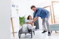 Father helping his son to drive a toy peddle car