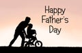 Father Helping his Young Child Learn to Ride Bike with Training Royalty Free Stock Photo