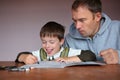 Father helping son doing homework Royalty Free Stock Photo