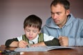 Father helping son doing homework Royalty Free Stock Photo