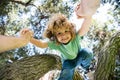 Father helping son. Fathers hand and helping son to climb tree. Child protection. Royalty Free Stock Photo